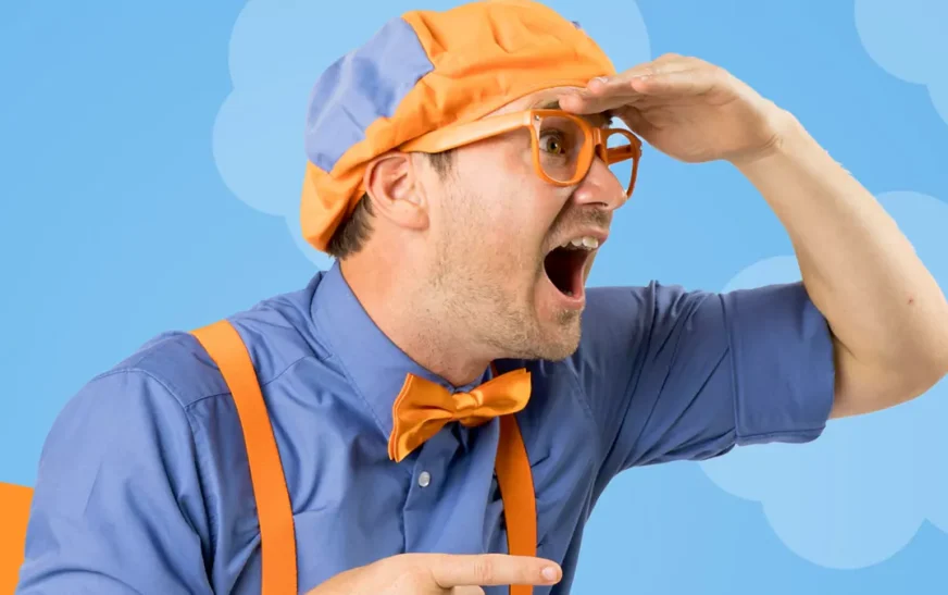 Blippi net worth represented by entertainer in signature blue and orange outfit with excited expression