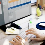 Person working on computer with spreadsheets and documents reviewing Orformi.ru platform security and legitimacy