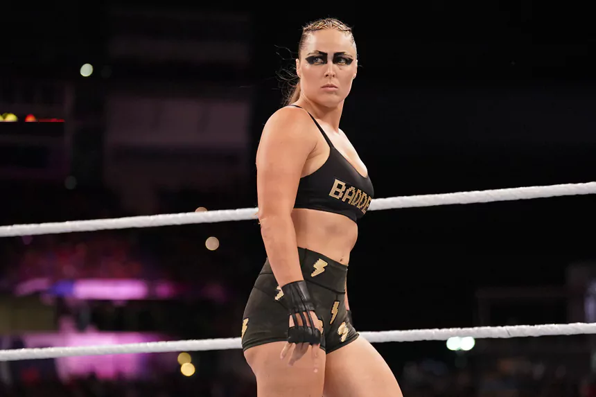 Ronda Rousey net worth — UFC champion and WWE wrestler in fighting stance