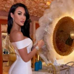 Corrie Yee wearing a white off-shoulder dress in a luxury interior setting