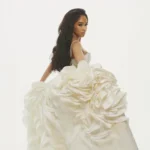 Saweetie wearing a white ballgown, representing her estimated $4 million net worth in 2026