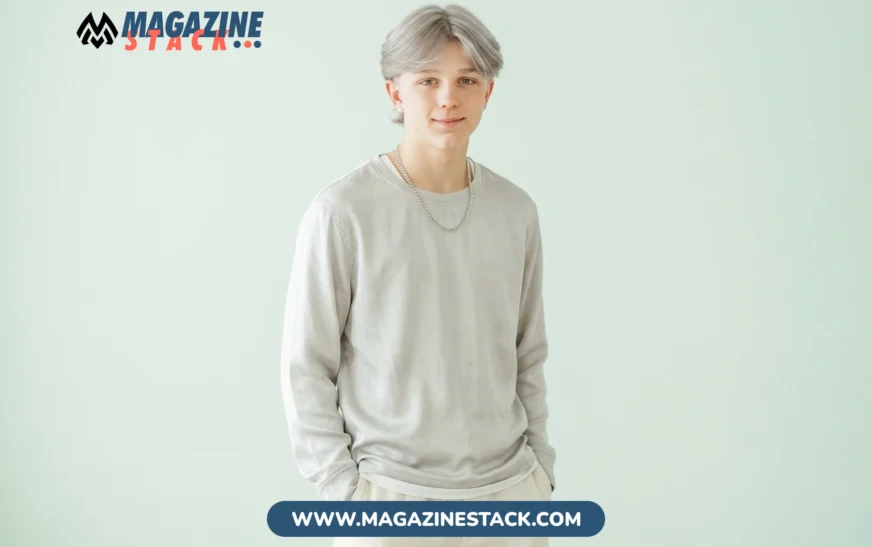 Dean Withers, American TikTok political commentator, in a studio portrait with silver hair and grey top