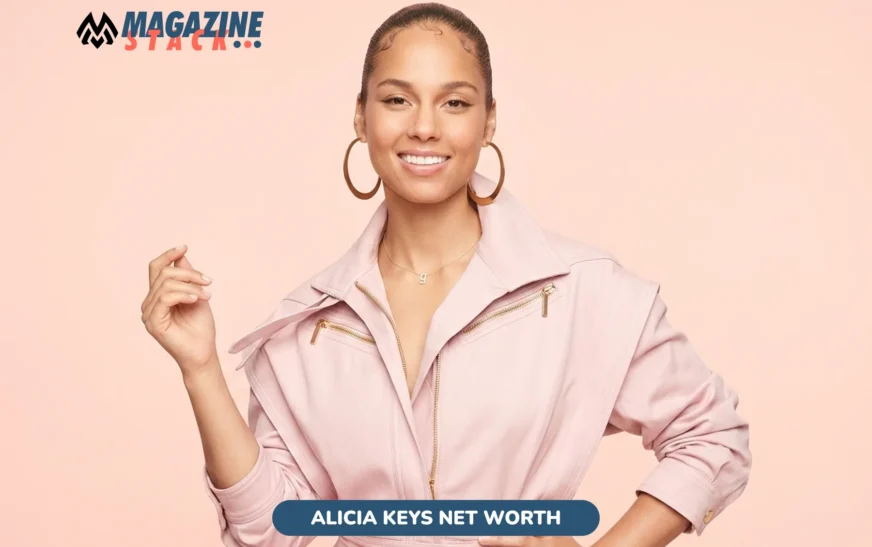 Alicia Keys net worth photo shoot, smiling in pink jumpsuit with hoop earrings