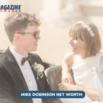 Mike Dobinson and Maisie Adam laughing together in a vintage convertible on their wedding day